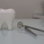 a picture of tooth and a dental mirror