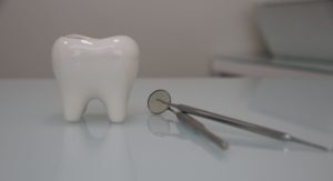 a picture of tooth and a dental mirror
