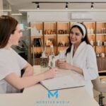A receptionist working with a client at the front desk in Med spa