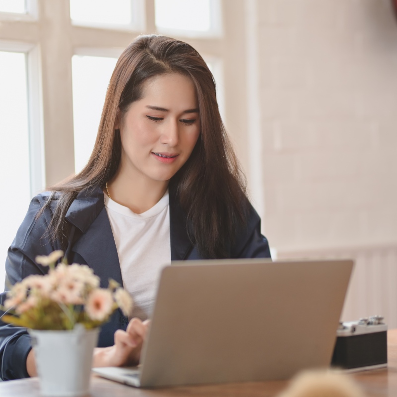 a woman using a computer to look at a medspa website