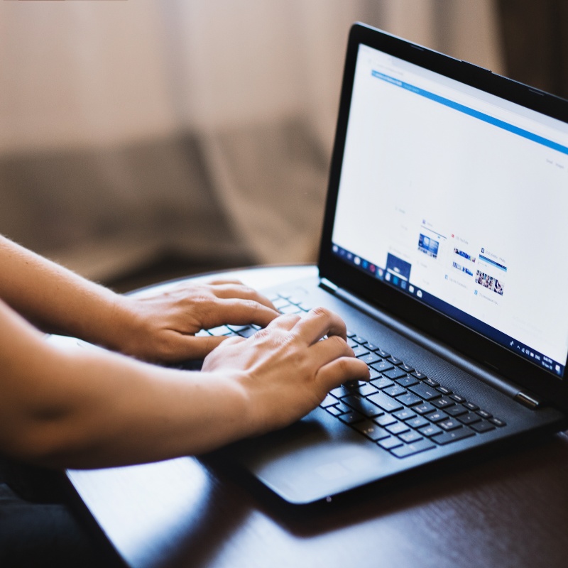 someone typing on a laptop