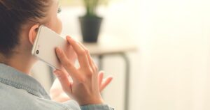 Woman talking on a smartphone during a consultation call.